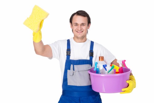Carpet cleaning technician preparing safe equipment in a Haringey property